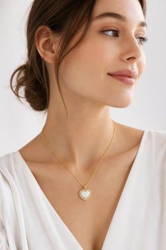 AYNOHA gold heart necklace with mother-of-pearl on white - worn by model