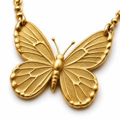 AYNOHA gold butterfly necklace on white - close-up detail
