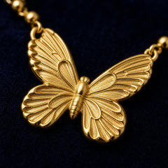 AYNOHA gold butterfly pendant necklace - close-up detail