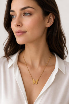 AYNOHA gold butterfly necklace on white - worn by model