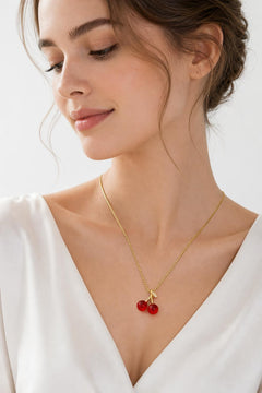 AYNOHA gold cherries necklace on white - worn by model
