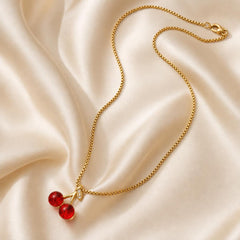 AYNOHA gold necklace with red cherries pendant - styled