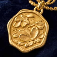 AYNOHA gold floral medallion necklace - close-up detail