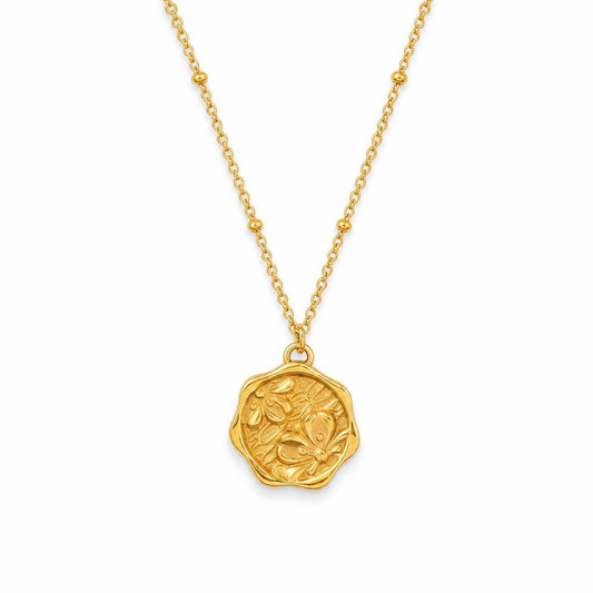 AYNOHA gold floral medallion necklace on white - studio